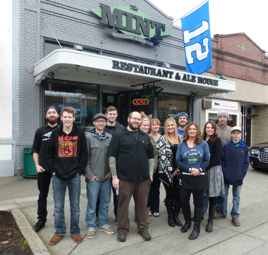 Mint Enumclaw Staff Welcomes You under Seahawks 12th Man Flag